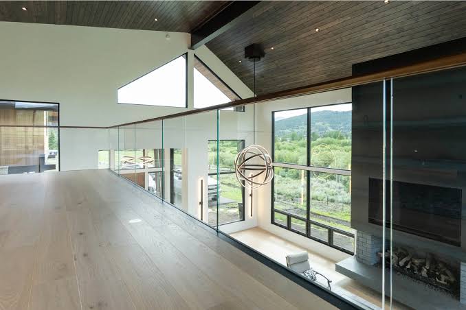 Channel-mounted glass railing on a loft overlook